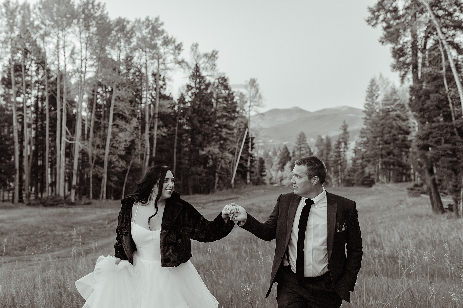 bride and groom hold hands 