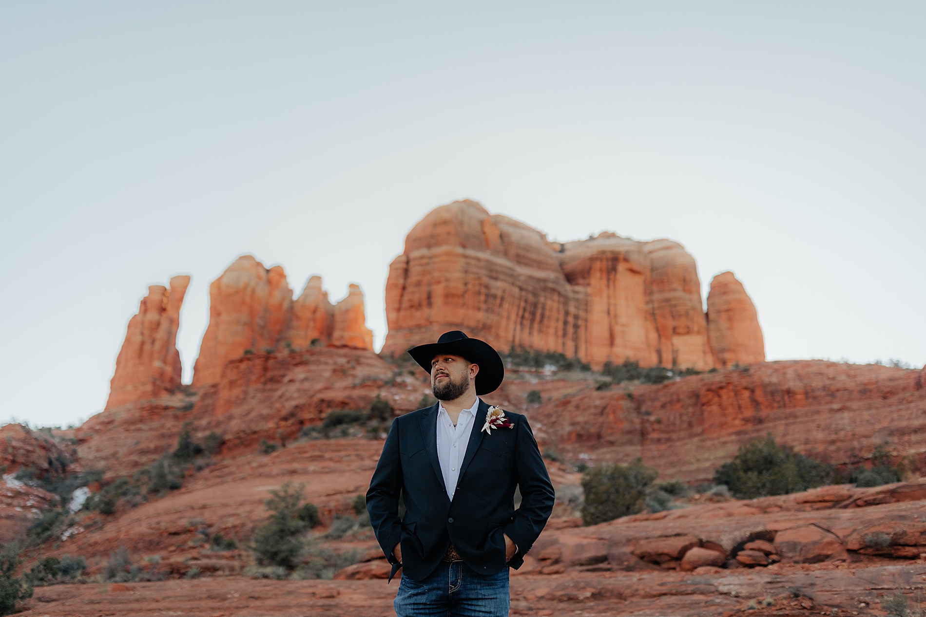 groom portraits in suit jacket and hat