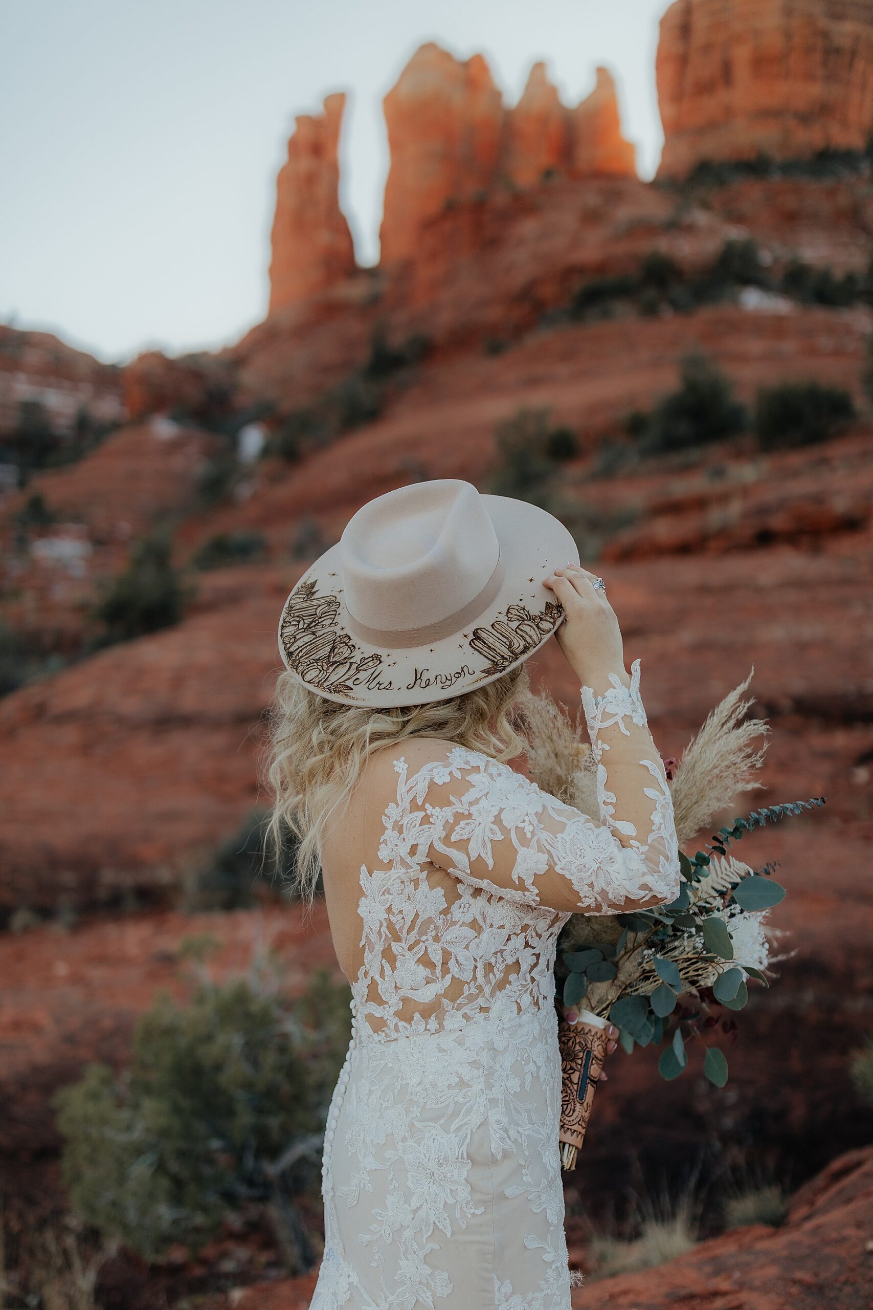 bride wears personalized hat 