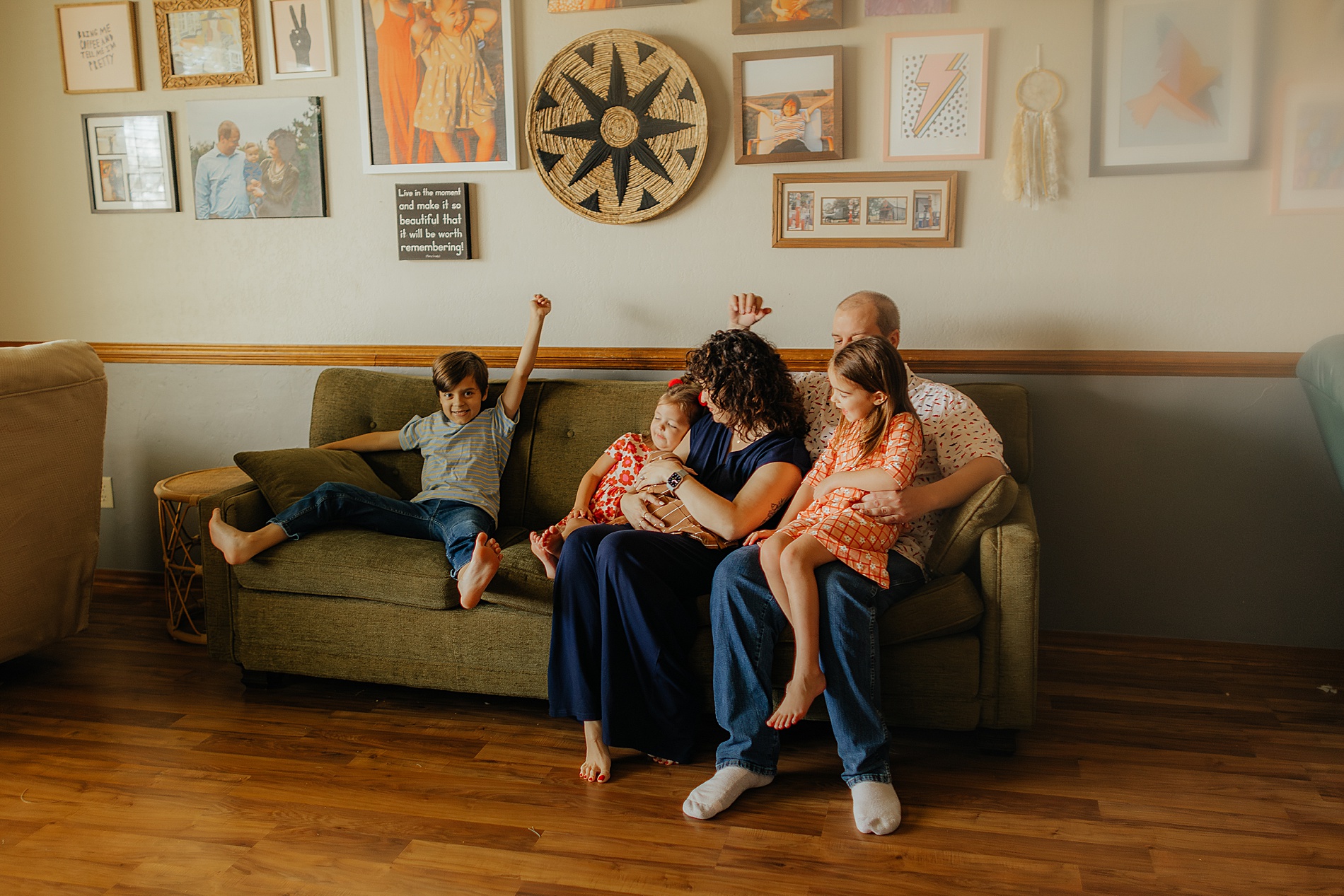 family snuggles on couch during in-home newborn session | The Beauty of Candid Lifestyle Photography
