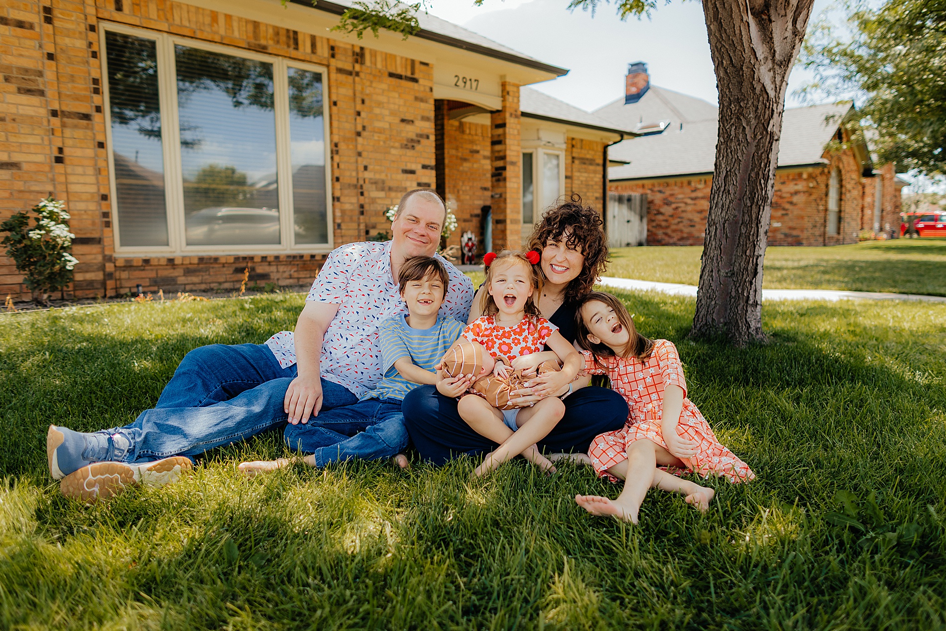 joyful family photo outside of Texas home