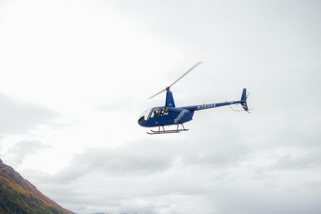 Helicopter flying above Knik Glacier after an Alaska helicopter elopement.