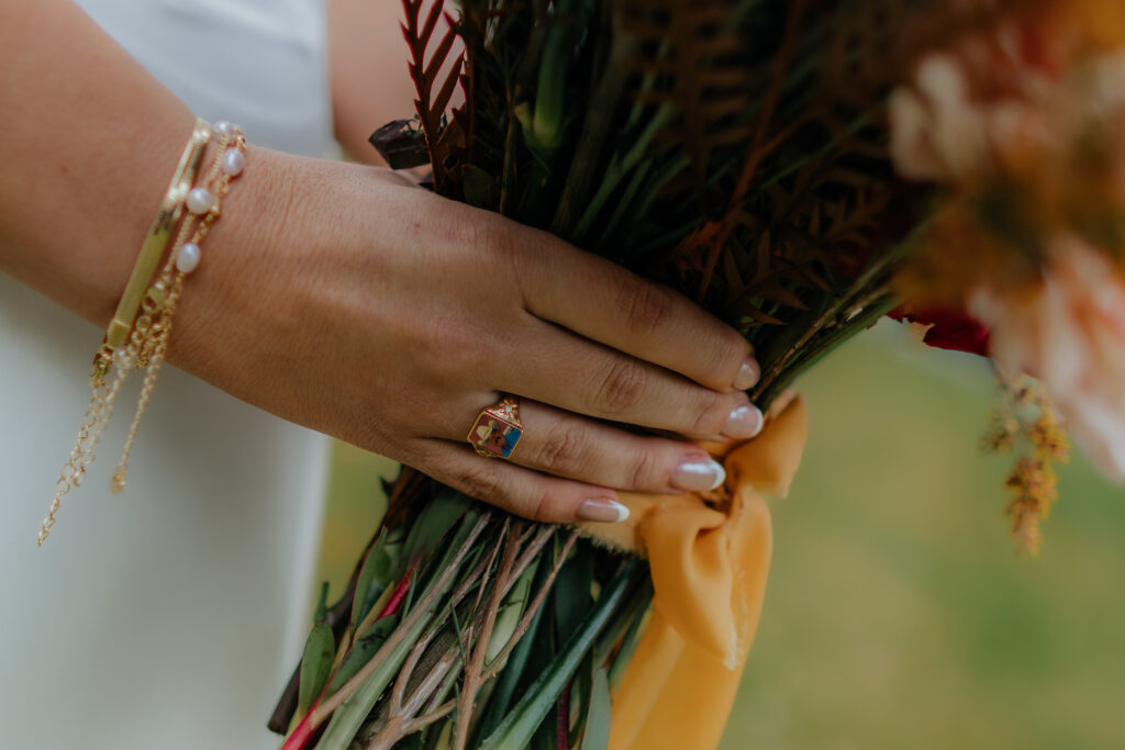 Bride's hand and bouquet before an intimate Alaska wedding.