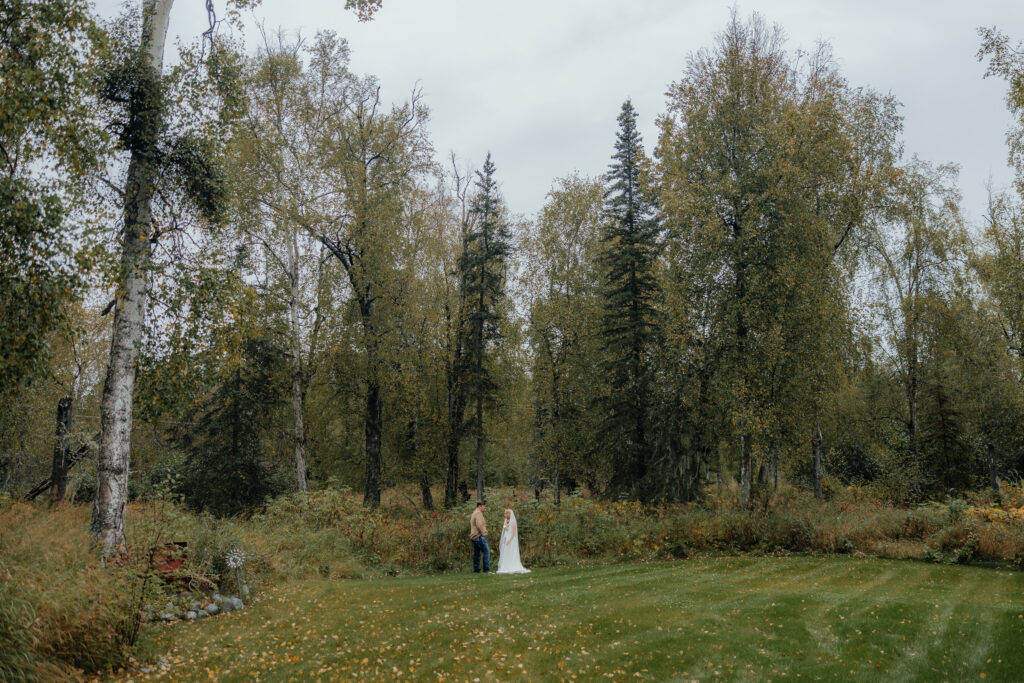 Bride and groom meeting for their first look surrounded by Alaska's fall landscape